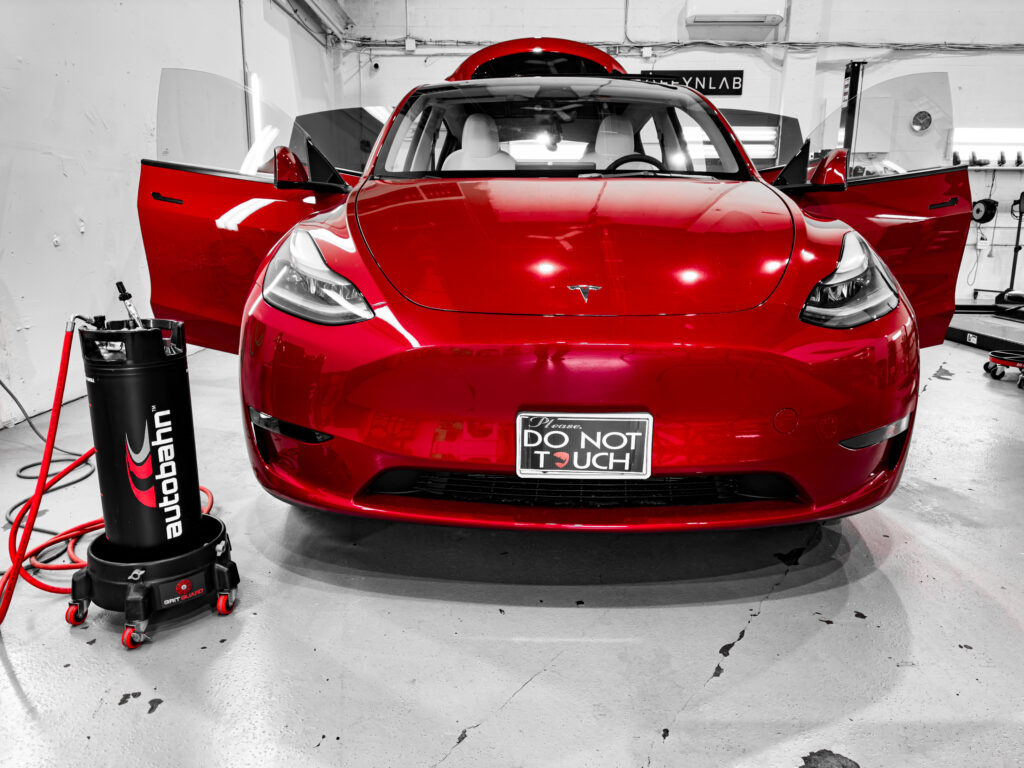 Tesla Model Y with paint protection film applied to the front end