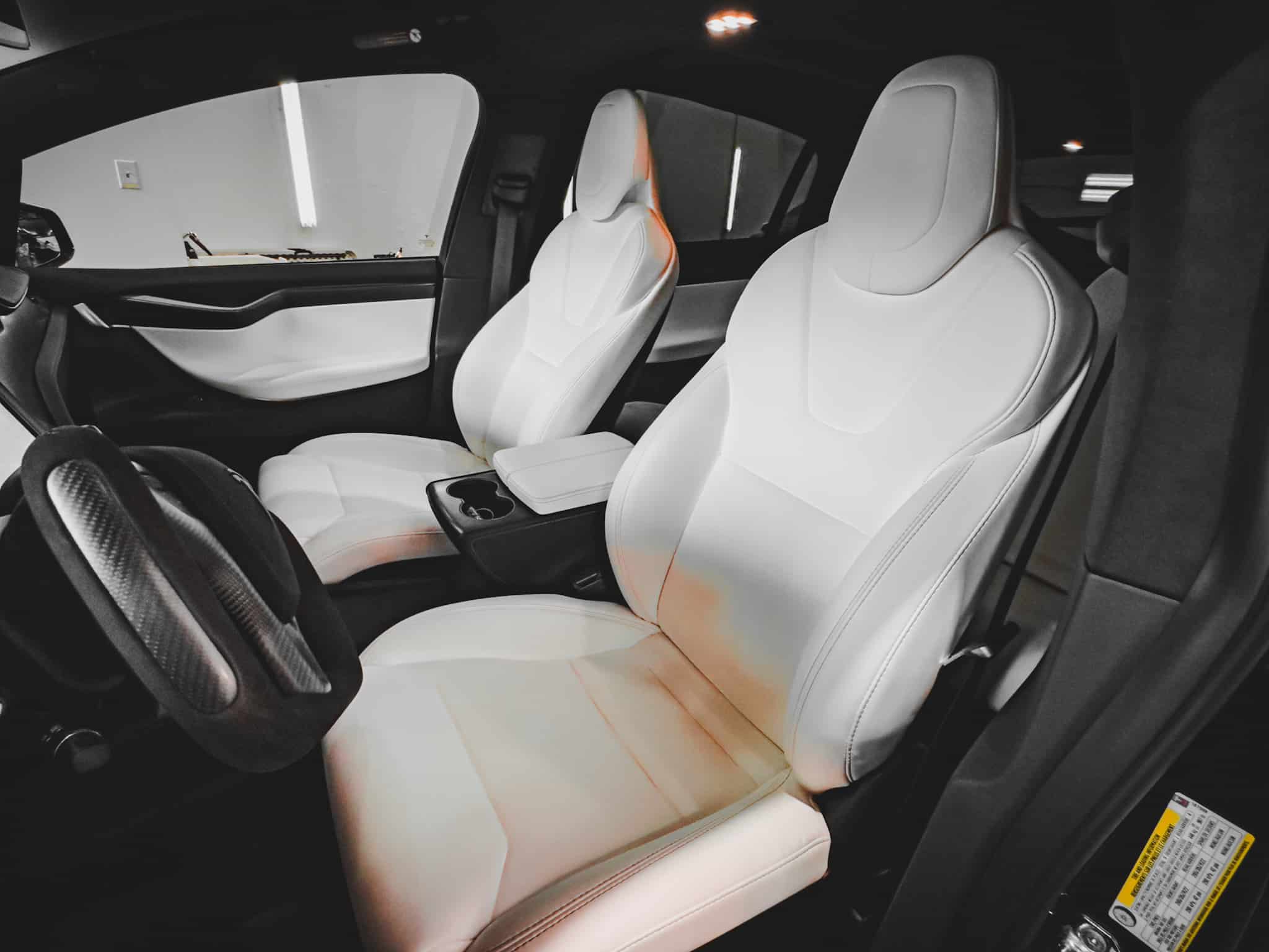Detailed white vehicle interior with full cleaning and surface treatment