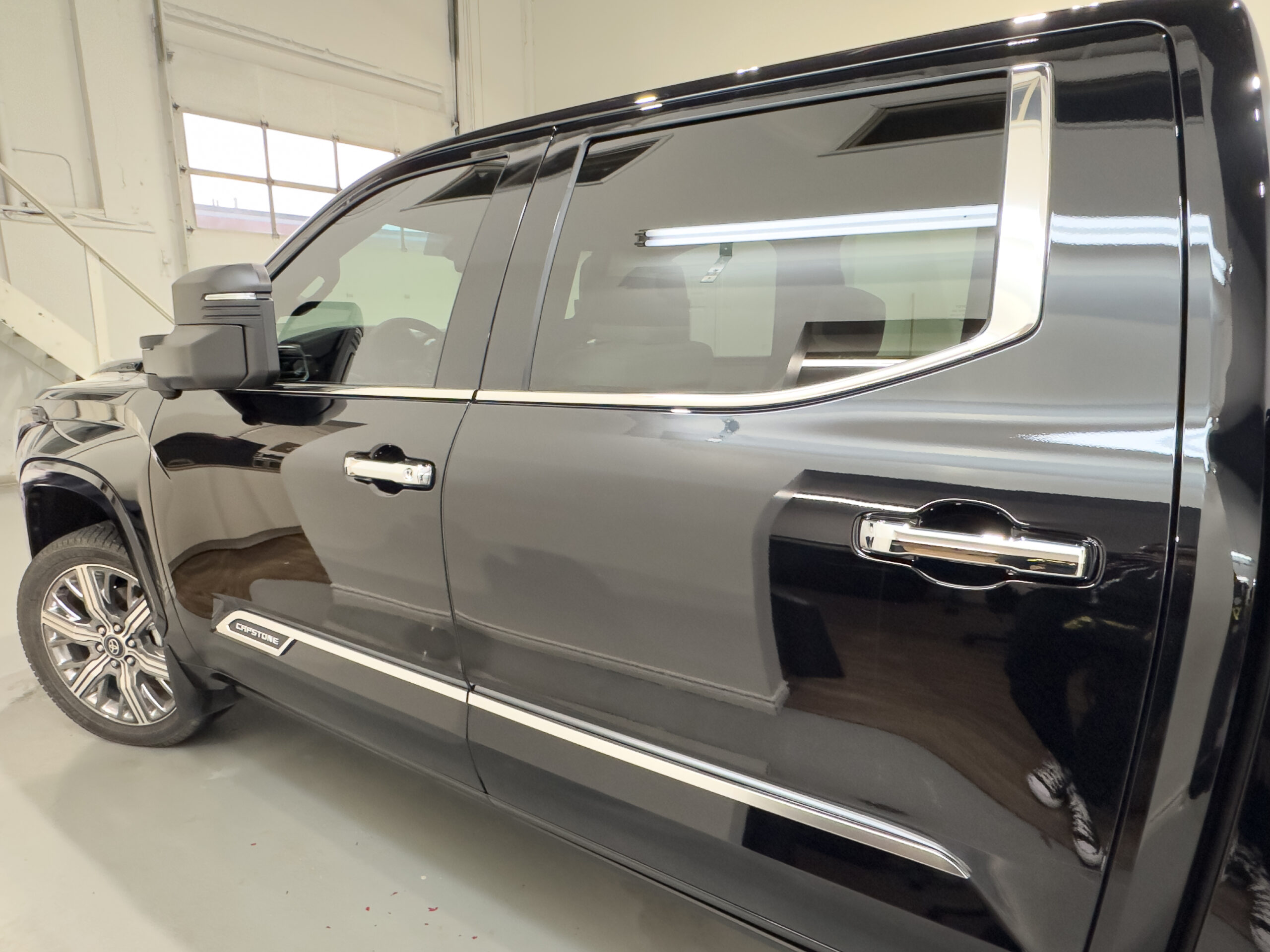 Automotive window tint installation on black GMC pickup truck at Evelyn Protective Films in Markham