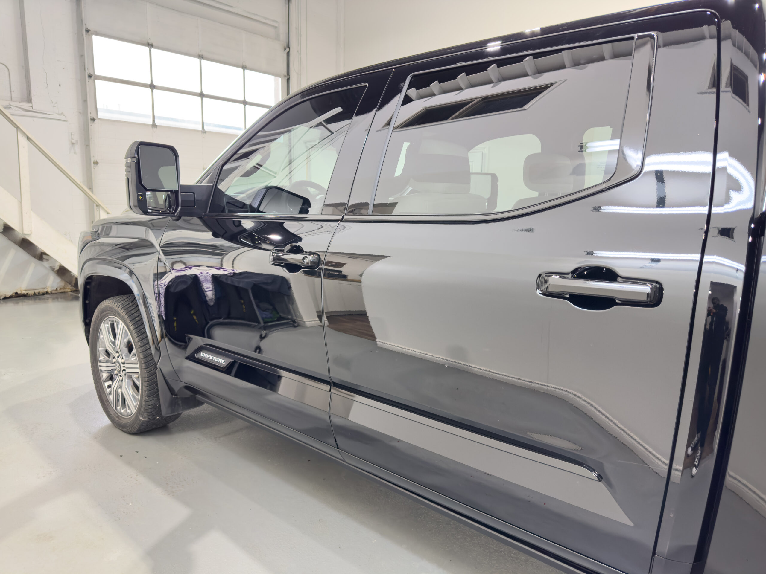 After chrome delete with gloss black window trim and door handles on a GMC pickup truck